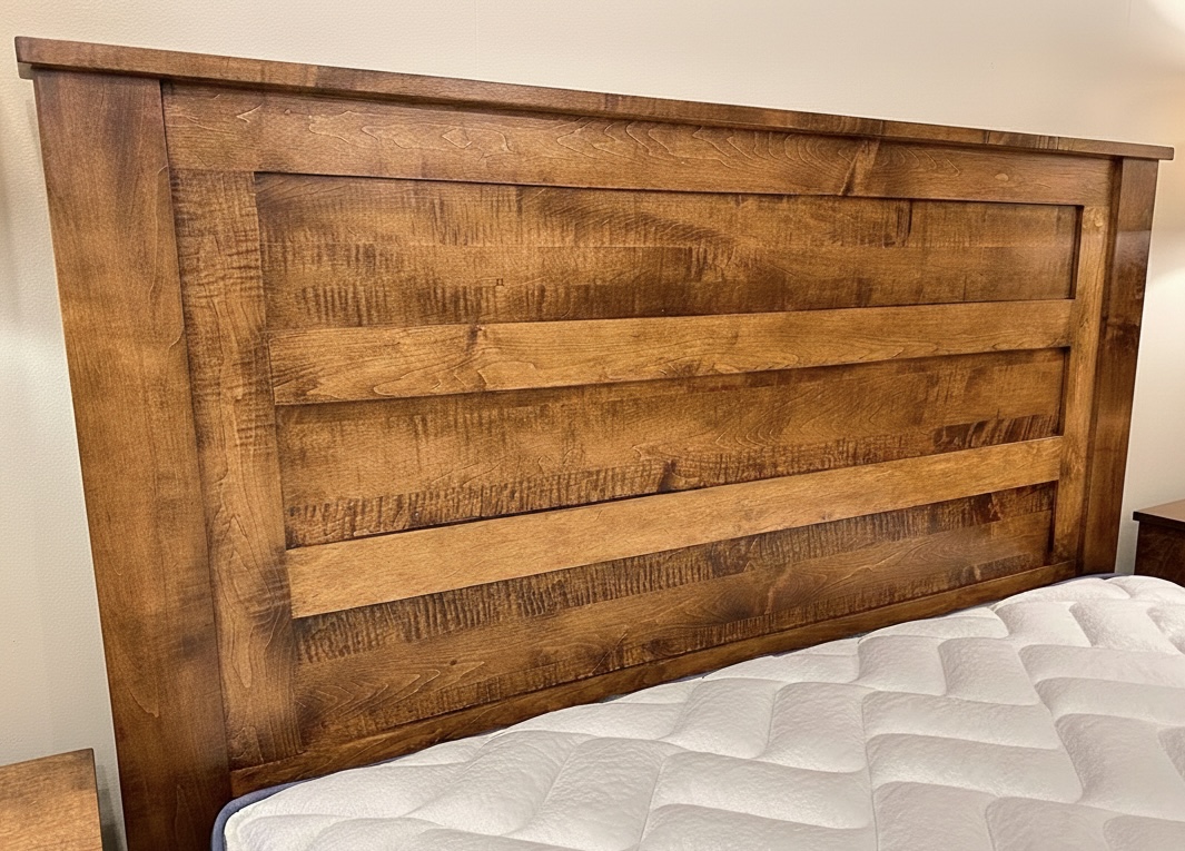 Custom hardwood bed headboard  - close-up showing horizontal plank detail and rich stain